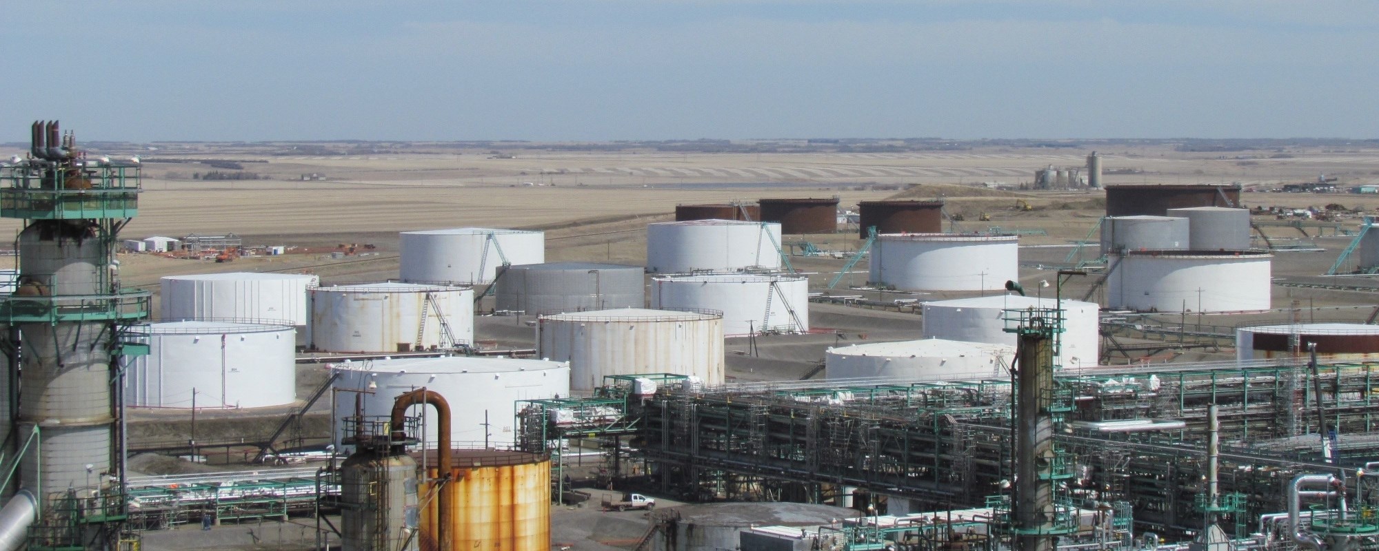 Refinery Storage Tanks with field in background